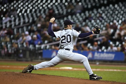 Selective Focus of Baseball Pitcher in 20 Jersey About to Throw Ball