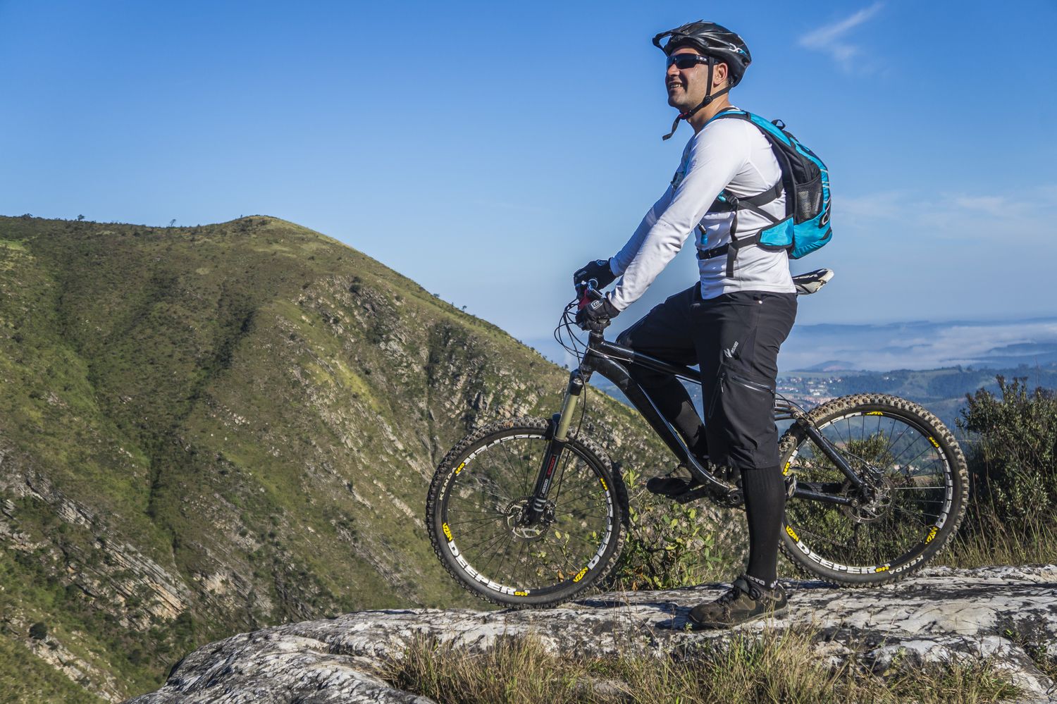 Cyclist riding a mountain bike with safety gear outdoors