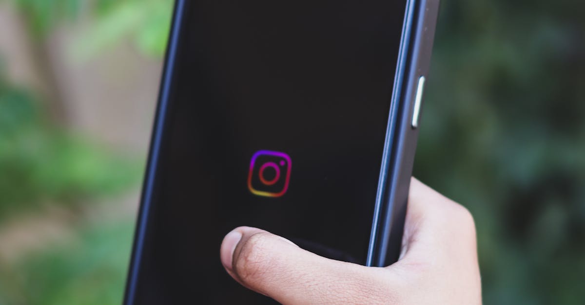A close-up of a hand holding a smartphone displaying the Instagram app with a green background.