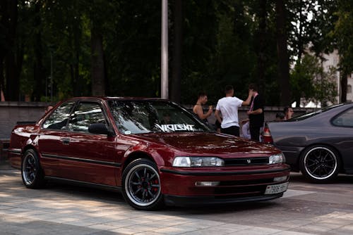 People Standing near Red Honda Accord