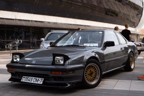 Free Vintage Honda Prelude with distinctive alloys parked in urban area. Stock Photo