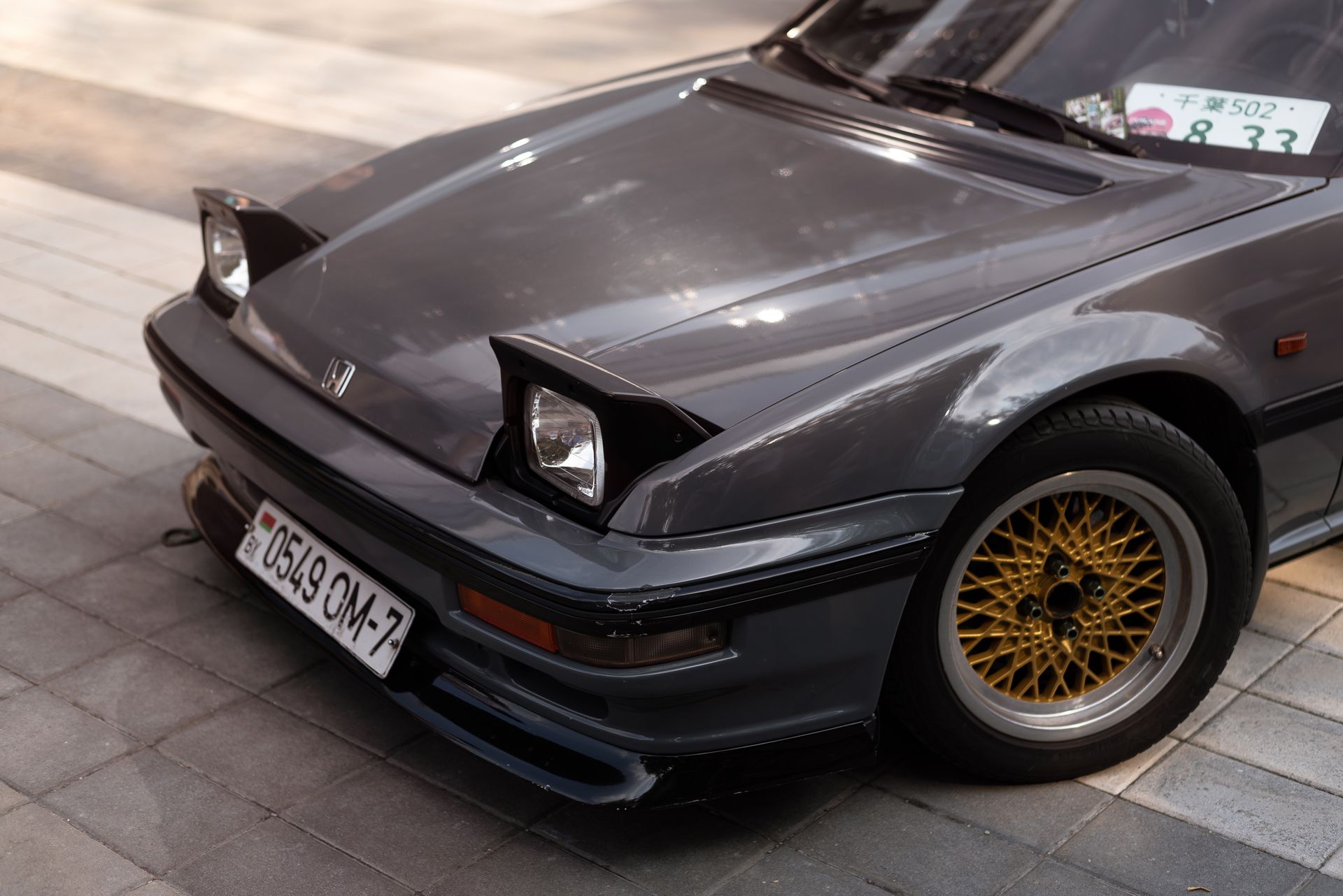Detailed view of a vintage gray Honda Prelude car front with unique headlights.