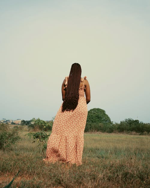 Woman in Dress Standing on Meadow