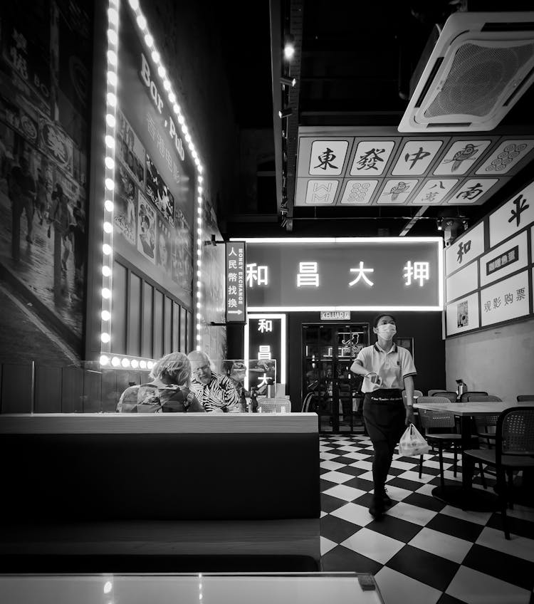 Waitress And Clients In Asian Restaurant 