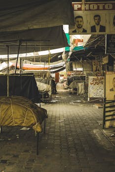 An empty outdoor street market with closed stalls and tents, conveying a peaceful atmosphere.
