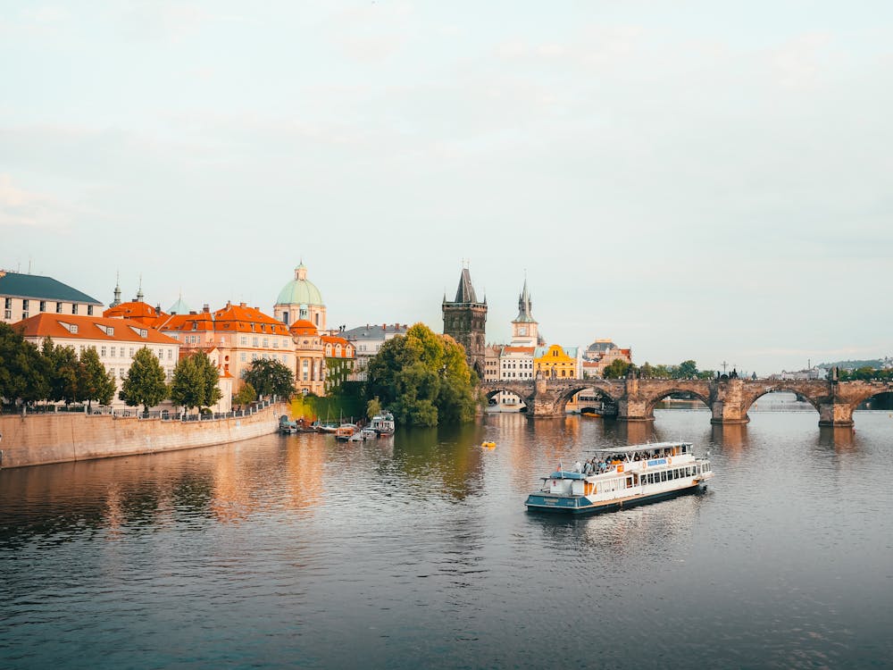 Free Prague old buildings and Charles Bridge at sunset Stock Photo