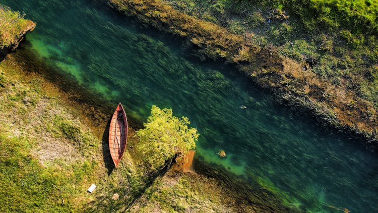 Traditional Wooden Boat On River Bank