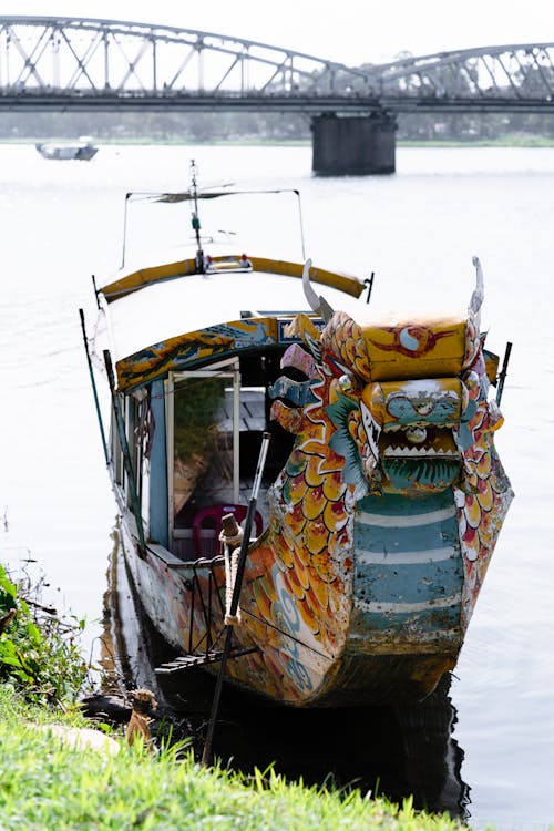 Richly Decorated Wooden Boat on Riverbank