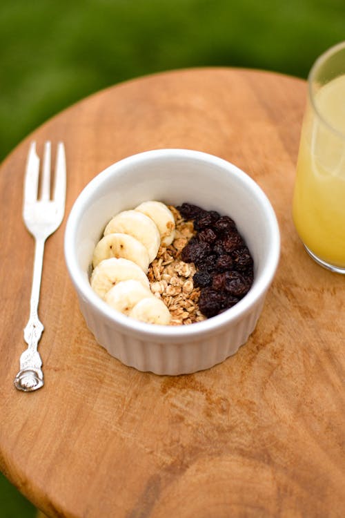 Granola and Fruits in Bowl on Wooden Table