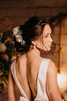 A stunning bride in a low-back dress, beautifully styled for an indoor wedding. - Fotografer Sidoarjo
