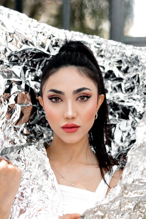 Beautiful Young Woman Posing with Silver Foil