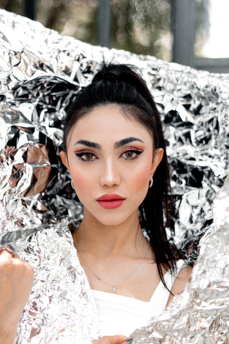 Beautiful Young Woman Posing With Silver Foil