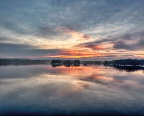 Free A tranquil winter sunset reflecting over Reads Landing Lake, Minnesota. Stock Photo