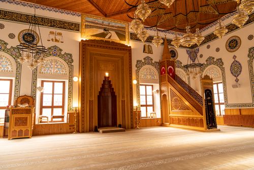 Free A beautifully decorated mosque interior in Turkey with chandeliers and ornate Islamic art. Stock Photo