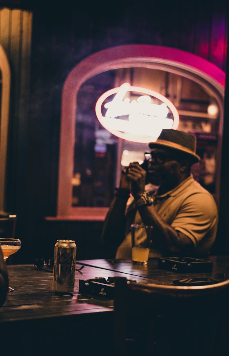 Man Sitting At The Table In A Bar 