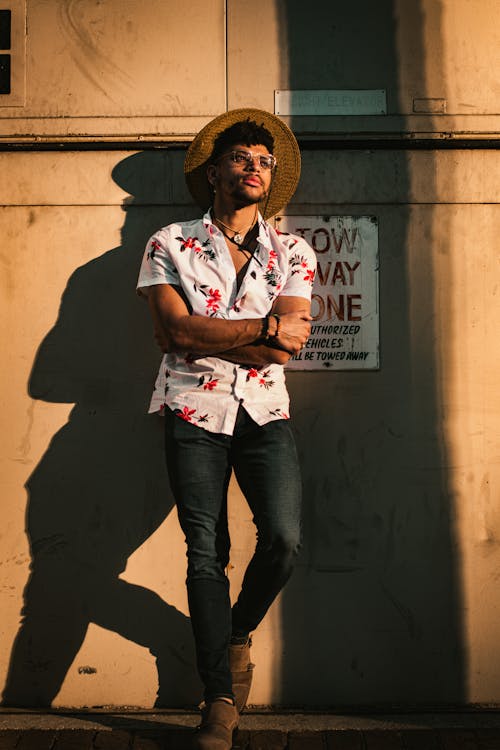 Man in Hat and Shirt Standing with Arms Crossed