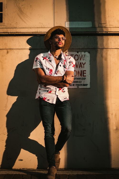 Free Fashionable portrait of a man in Tampa, Florida, standing against a sunlit urban wall. Stock Photo