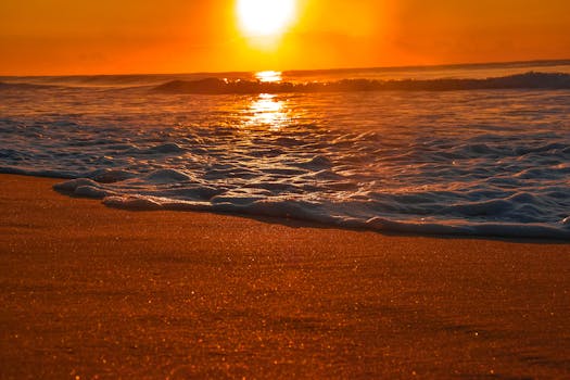 Experience peace with a stunning golden sunset over a serene beach, capturing the beauty of nature.