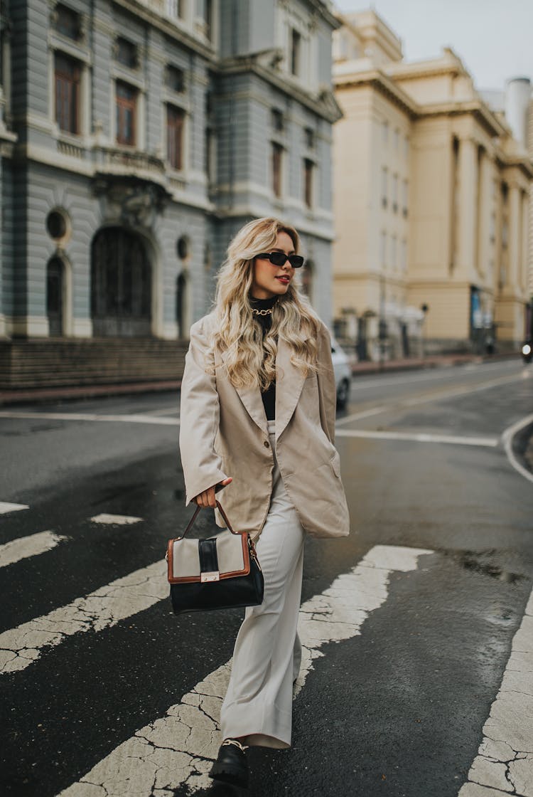 Woman Walking In City In Jacket And Pants