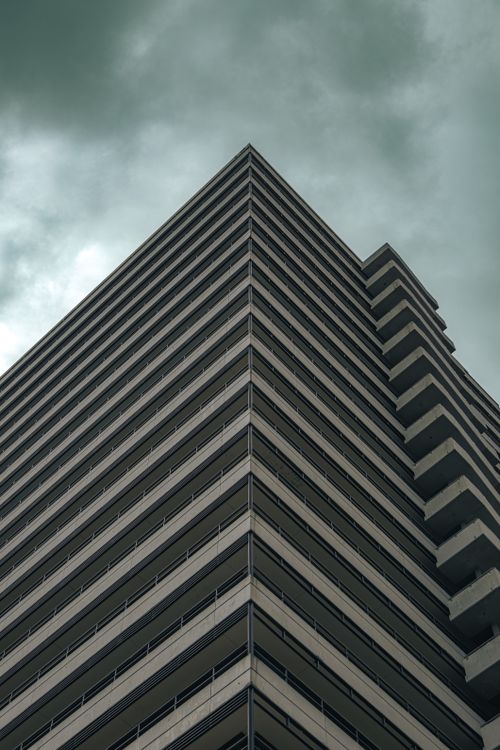 Free Low angle view of modern skyscraper in Buenos Aires, capturing architectural beauty against a moody sky. Stock Photo