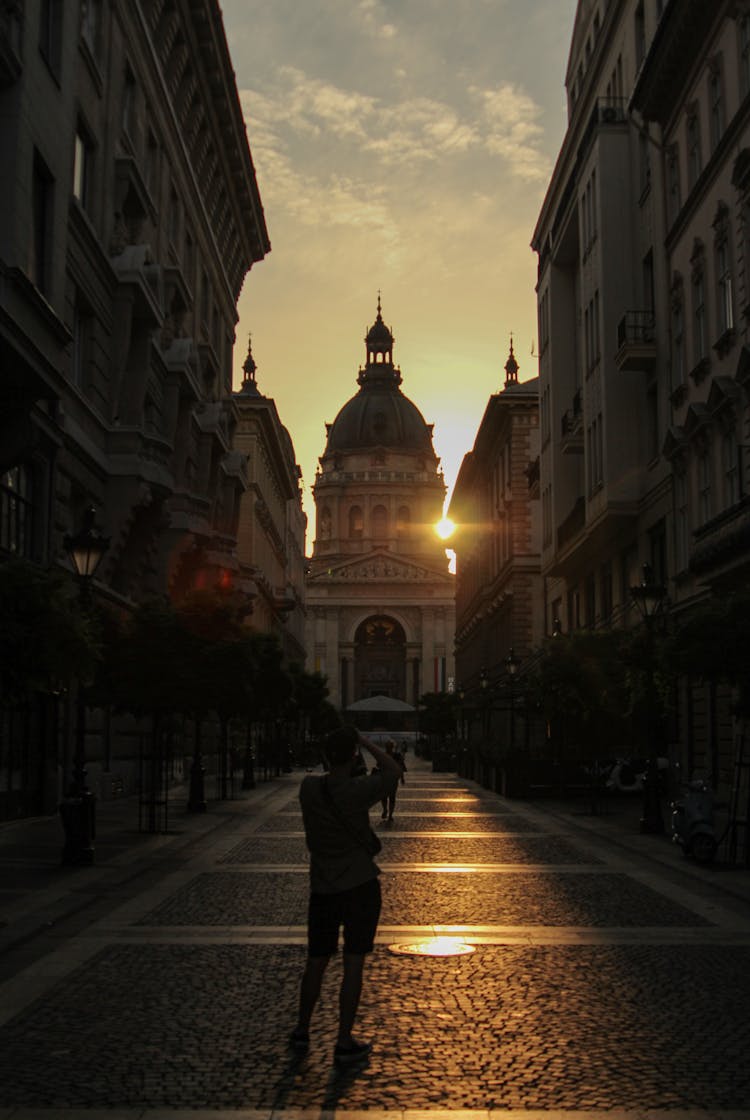 St Stephens Basilica Behind Street In Budapest At Sunset