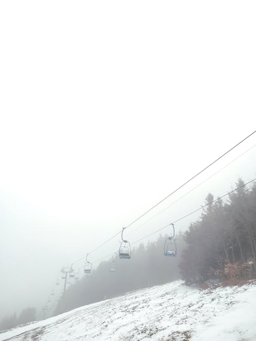 A Ski Lift in Mountains in Fog 