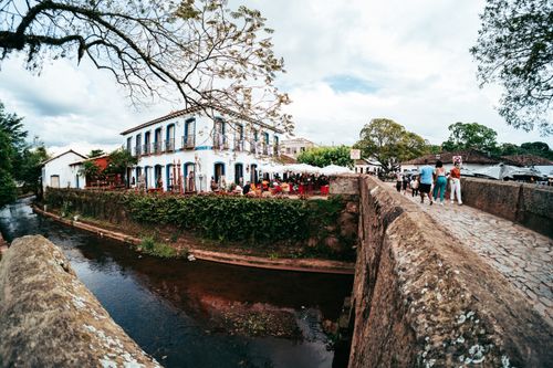 Free Lively street scene captured in Tiradentes, Brazil, featuring a historic bridge and bustling atmosphere. Stock Photo