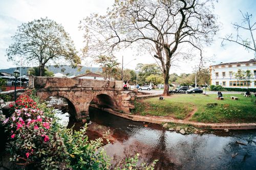 Free Peaceful scene of a historic stone bridge over a stream in Tiradentes, Brazil. Stock Photo