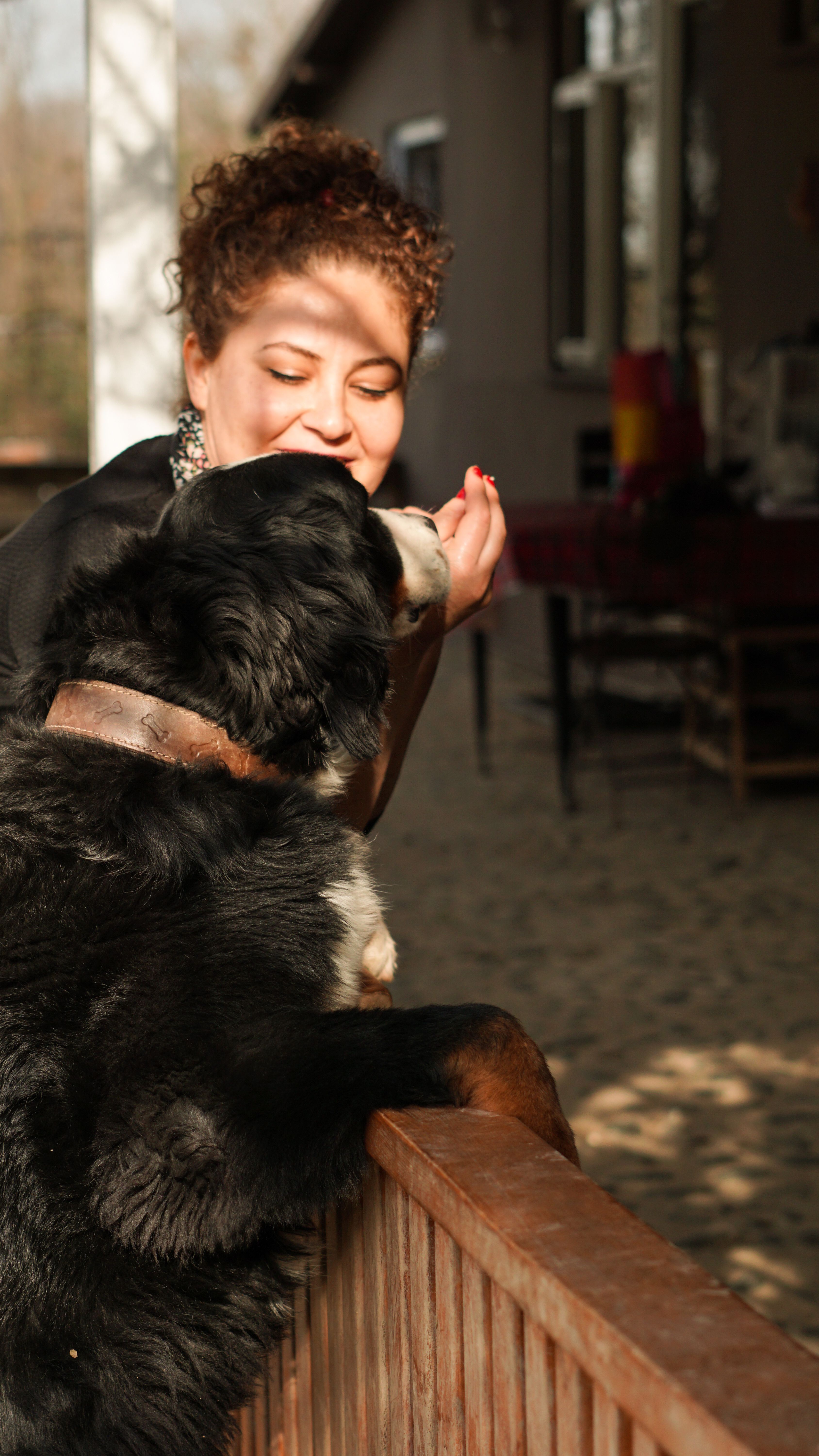 A woman shares a heartfelt moment with her dog in an outdoor setting, capturing a bond of love.