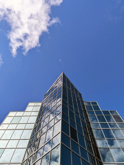 Free Low angle view of a modern glass office building against a clear blue sky in Halifax, Canada. Stock Photo