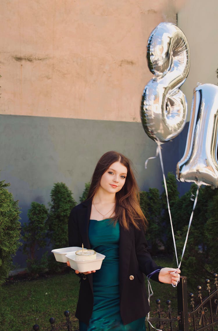 Woman Holding Birthday Balloons And Birthday Cake