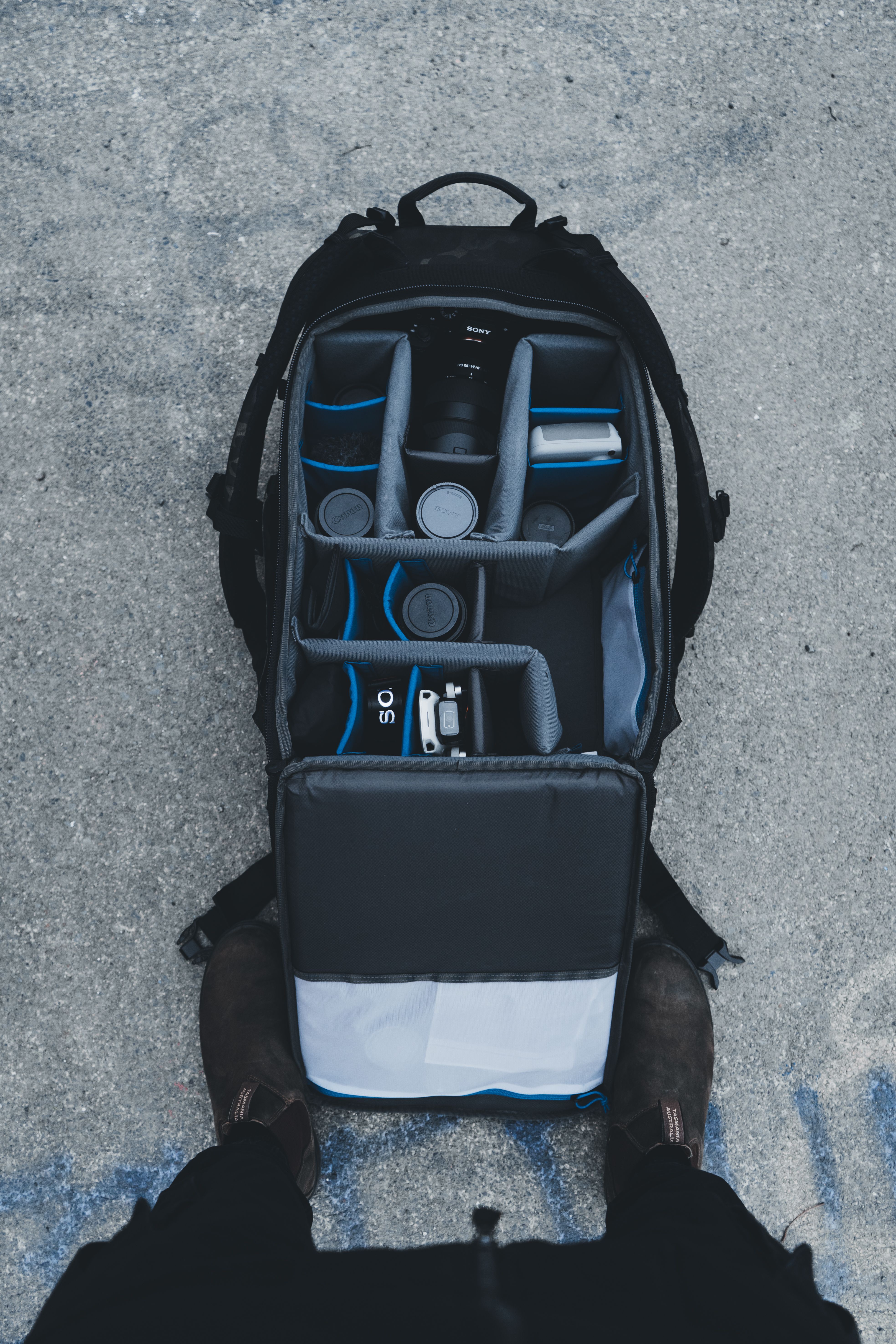 Top view of an organized camera backpack filled with photography equipment and accessories.