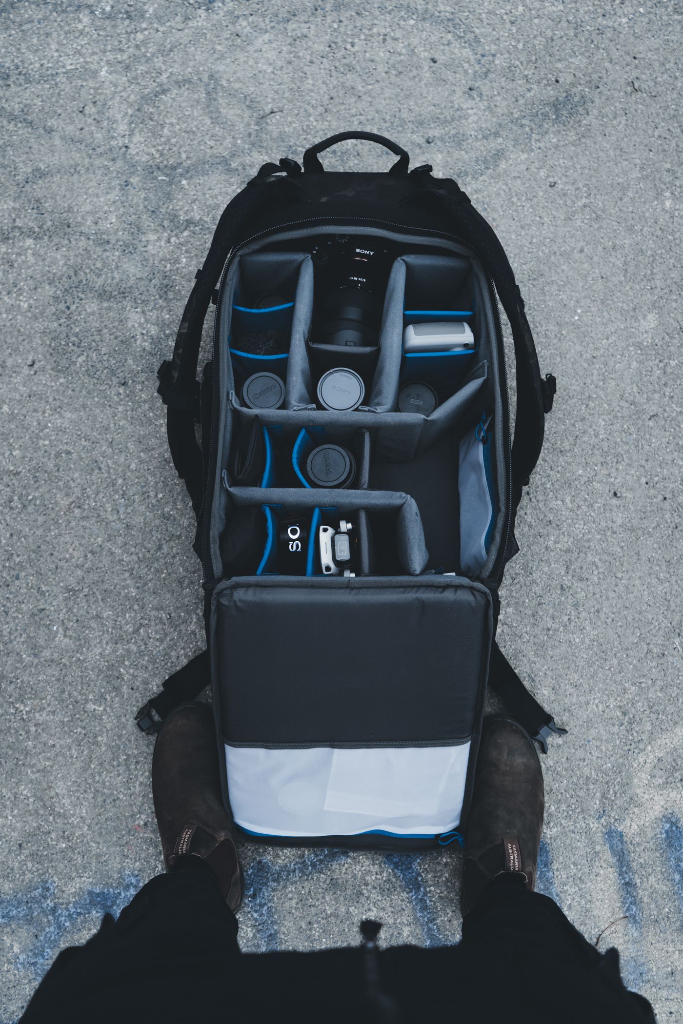 Open backpack showing padded compartments organized for carrying electronics while traveling