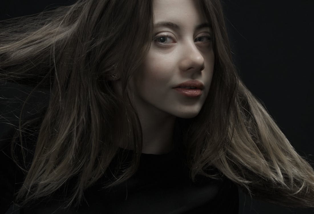 Studio Portrait of a Young Woman with Messy Hair