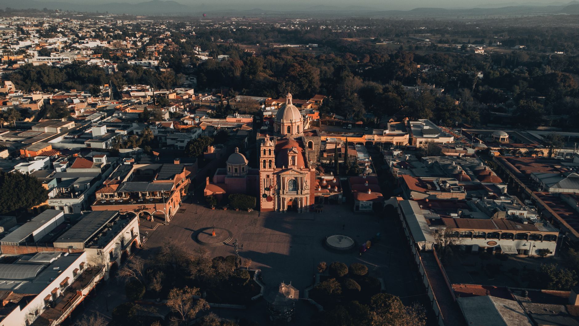 Aerial view of a historic church surrounded by an old town's urban landscape.