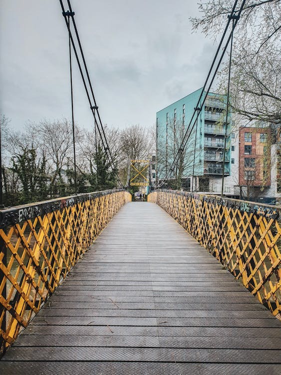 Urban Footbridge with Yellow Railing · Free Stock Photo