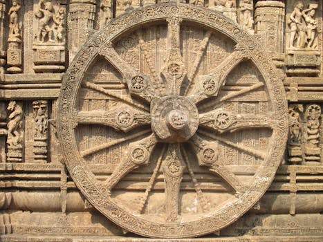 Intricate stone wheel carving from the Konark Sun Temple, showcasing exquisite architecture.