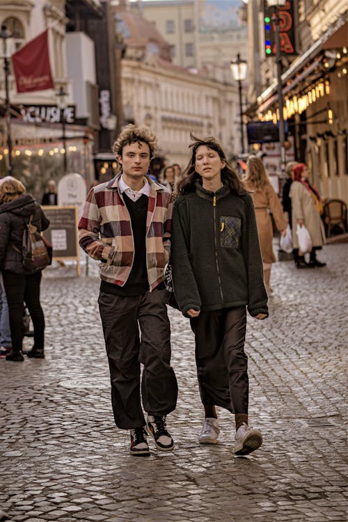 Couple Walking on Cobblestone Street