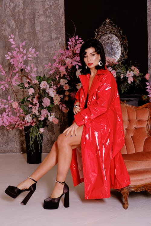 Young Elegant Brunette Wearing a Red Coat and High Heels 