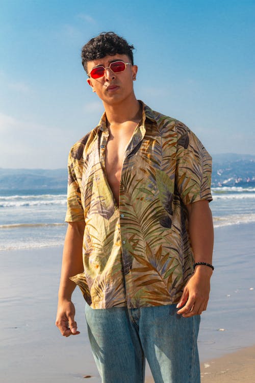 Young Man in a Shirt Standing on the Beach 