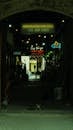A Dark Alley with Neon Signs of Restaurants