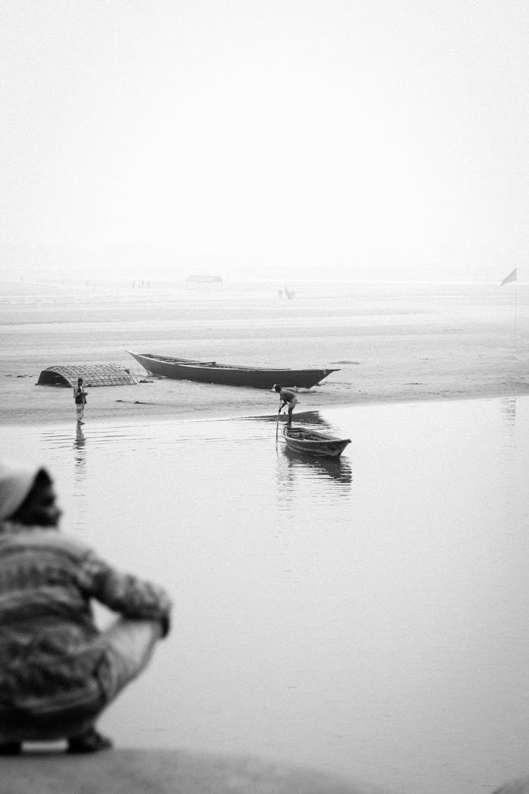 Black And White Photo Of Boats And Children On The Seashore