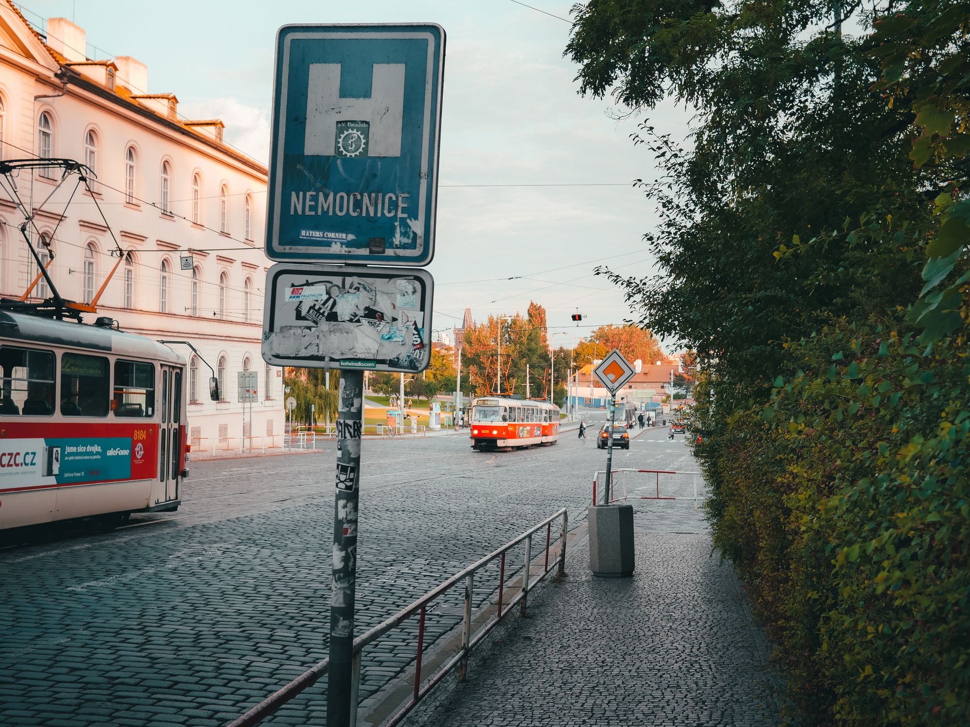 Historic tram line on cobblestone street in Prague, showcasing urban transportation and architecture.