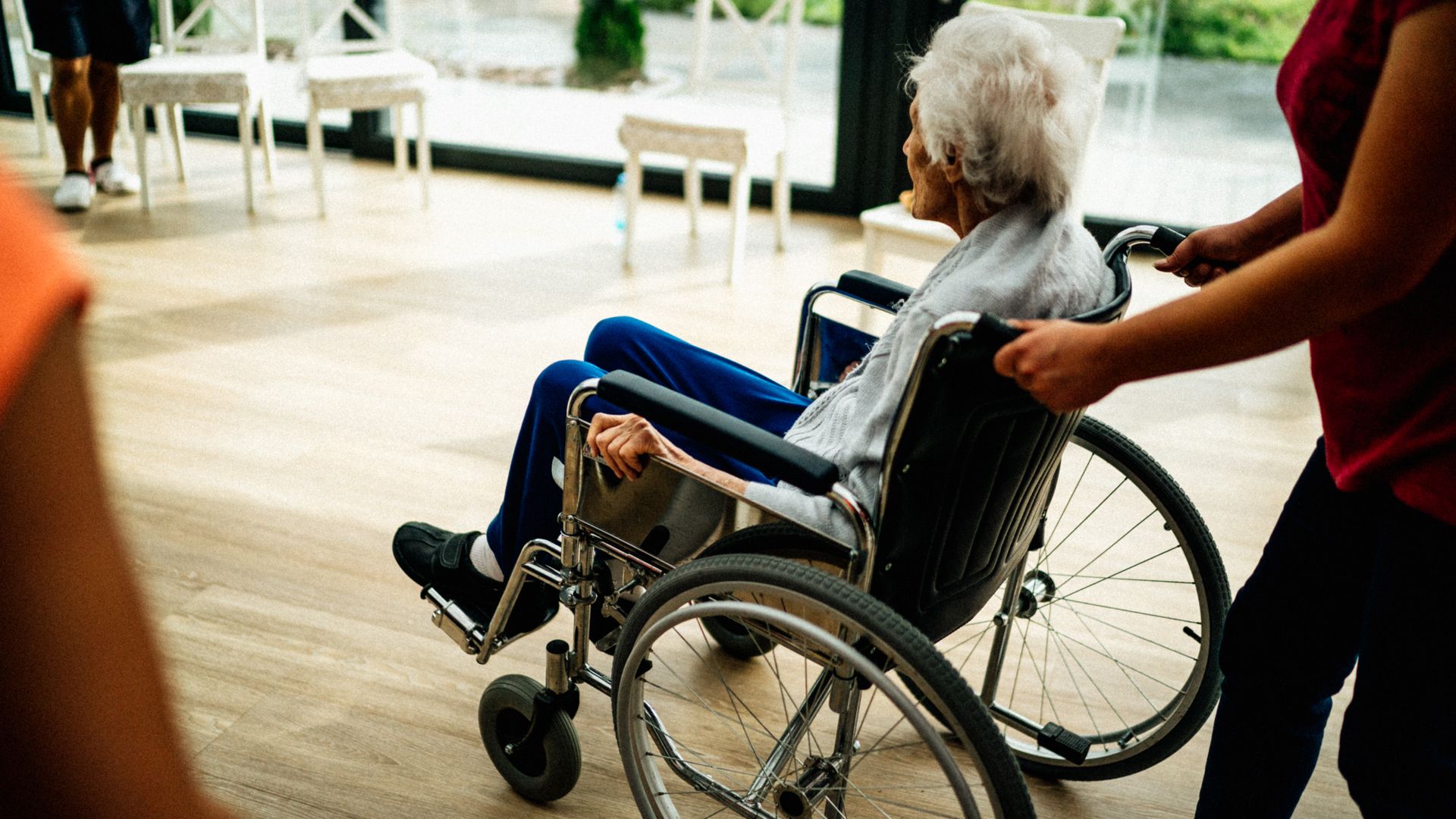 Modafinil Use in Elderly Patients: Exploring Benefits and Considerations A caregiver assists a senior adult in a wheelchair at a nursing home in Prague, Czech Republic — modafinil use in elderly patients