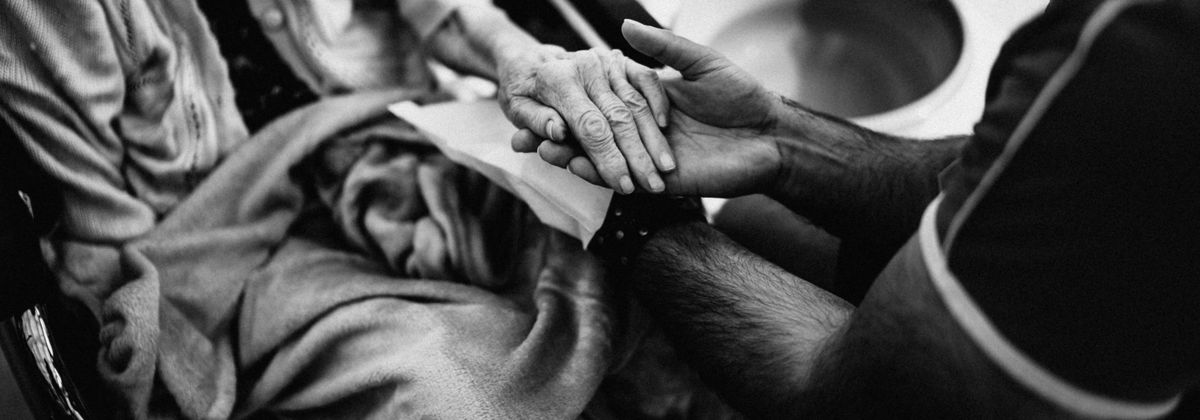 Two people holding hands in comfort