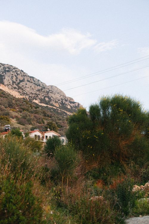 Free Idyllic rural scene with lush greenery and charming hillside houses. Stock Photo