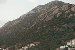 Charming village nestled in the mountains under a clear sky, highlighting a serene landscape.