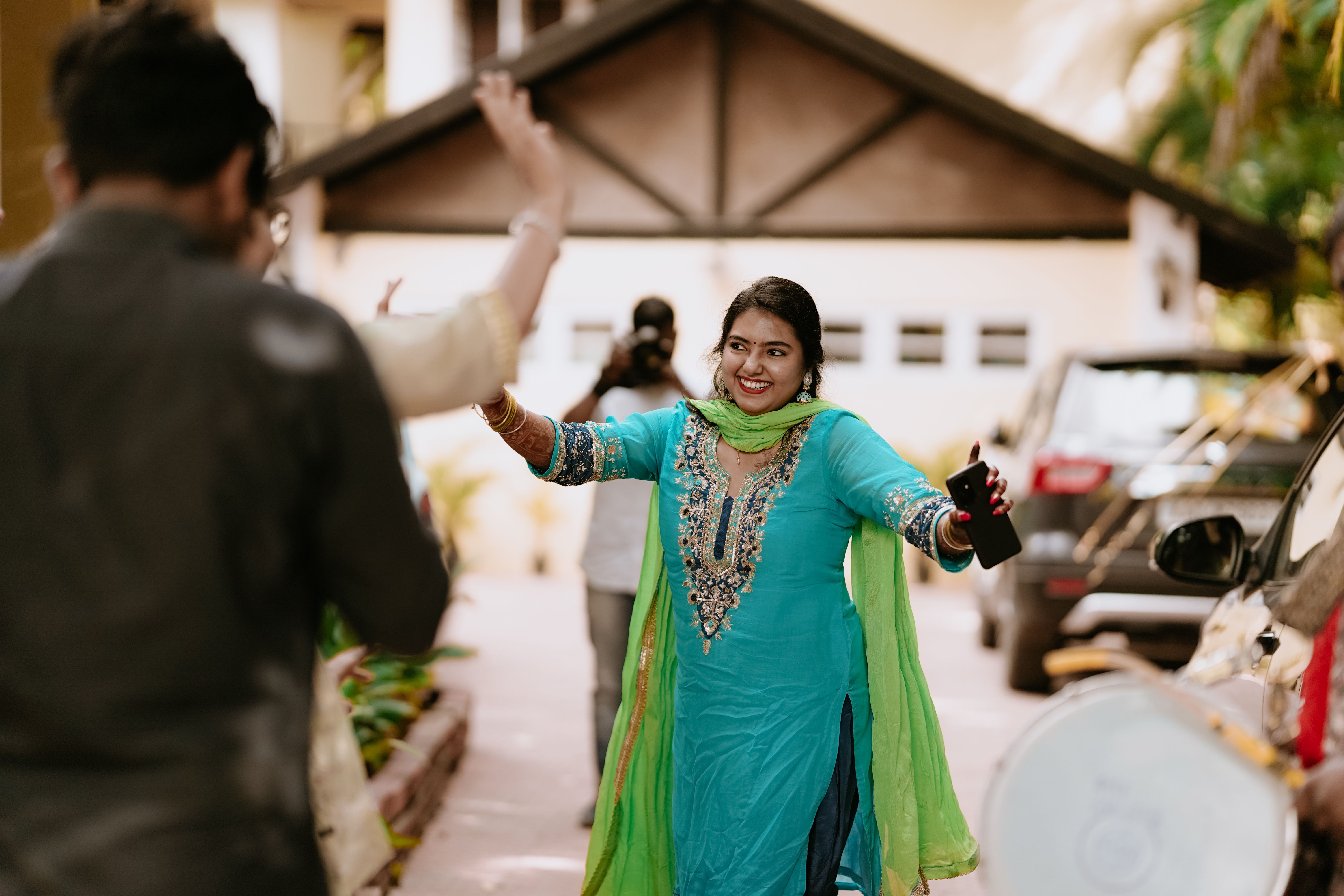 Smiling Woman in Traditional Dress Dancing Outdoors · Free Stock Photo
