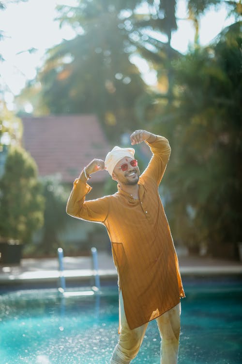 Man in Traditional Indian Clothing Standing in the Pool 
