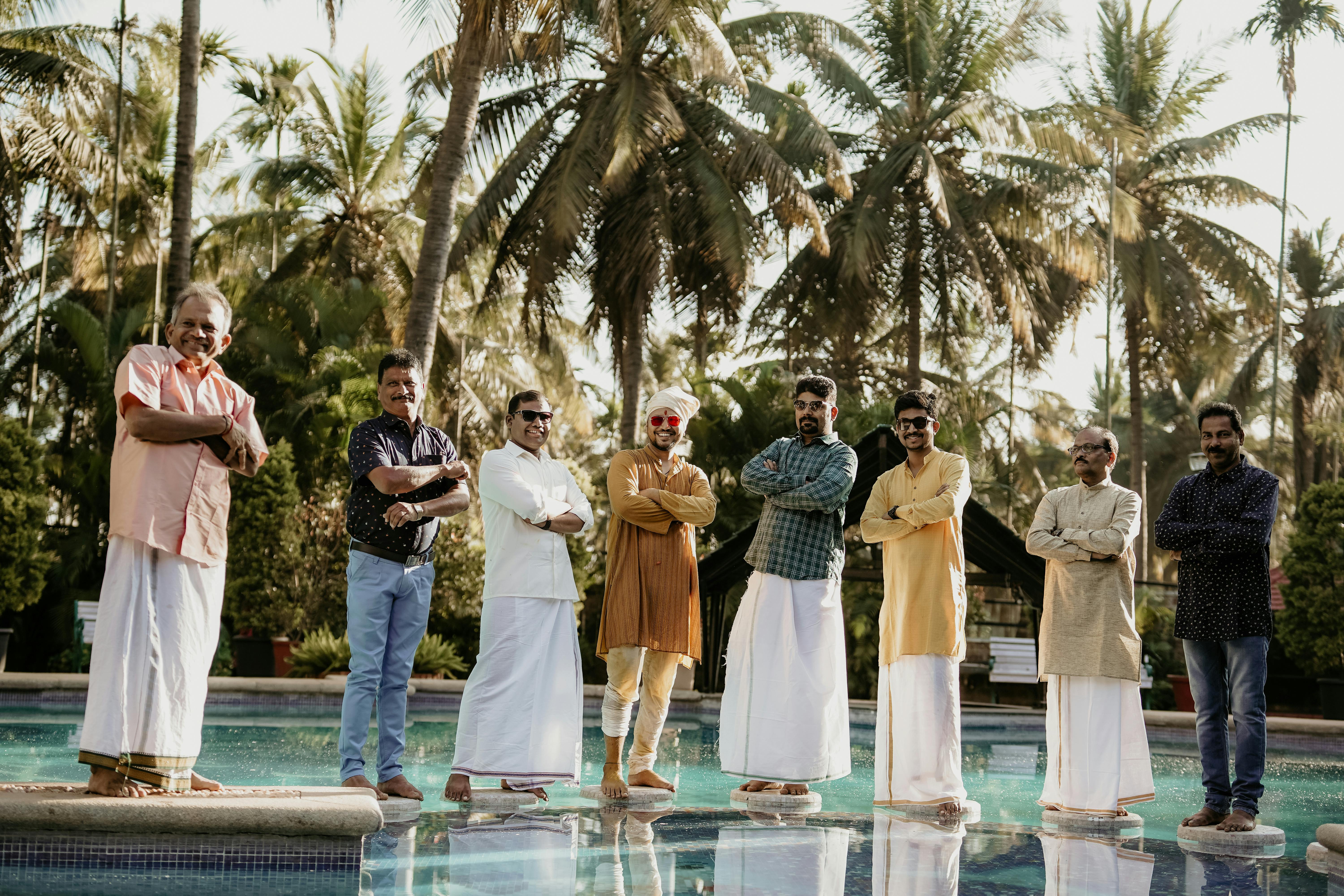 men in traditional clothing posing for a picture at a wedding